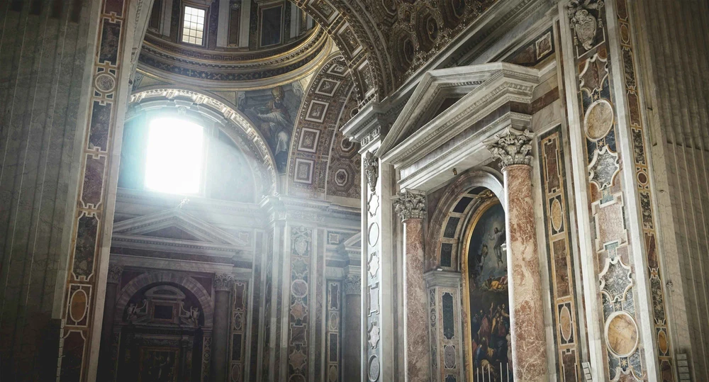 St. Peter's Basilica in Vantican City, Rome. Light streaming in through a window illuminating the finely crafted interior. 